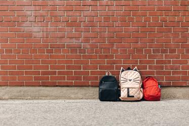 three-childrens-backpacks-brick-negative-space_373x.jpg